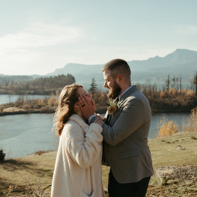 A couple looks at each other with love in the Columbia River Gorge on their wedding day.