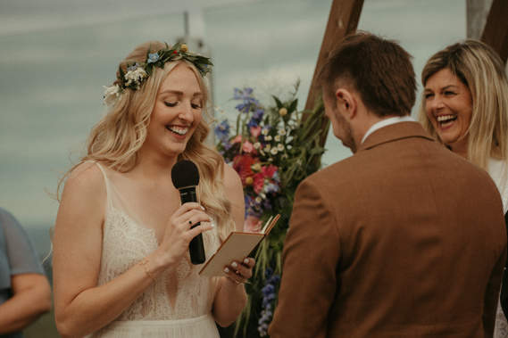 couple reading vows to each other during wedding ceremony