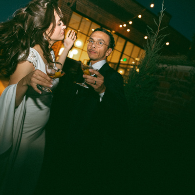 A stylish couple dancing with cocktails on their wedding day at The Whim in Minneapolis MN.