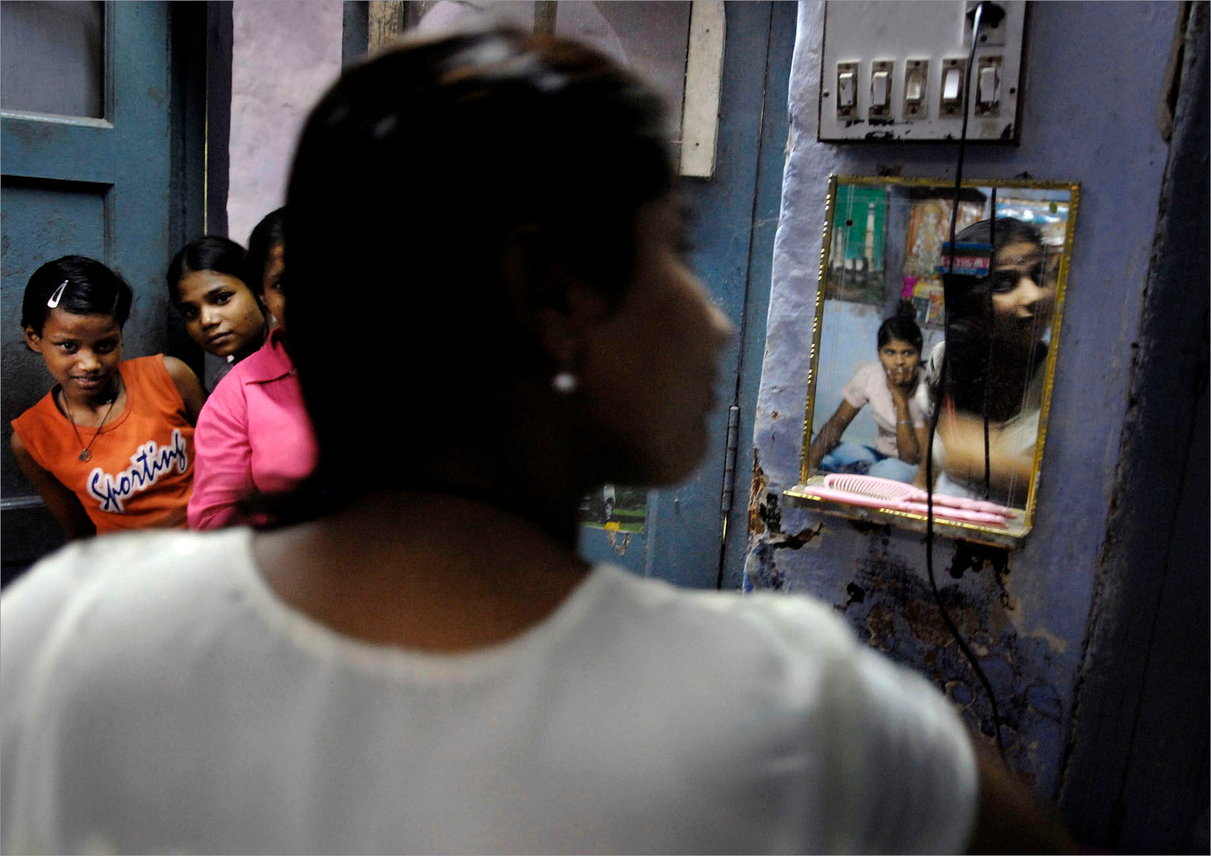 Kanpur-Hindu Orphanage in Kanpur, India, is filled with girls, many dropped off as infants by parents who wanted only boy babies. A young woman who grew up in the orphanage primps at the mirror in the room she shares with several other girls.