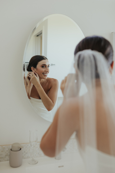 Bride gets ready at her parents house during her wedding