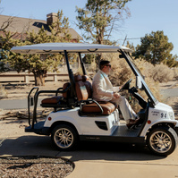 Photo of the groom driving a golf cart during his Brasada Ranch wedding in Oregon