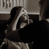 photo of bride getting makeup done at Brasada Ranch at her wedding in Bend Oregon