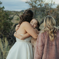 cousin hugging bride at Brasada Ranch wedding