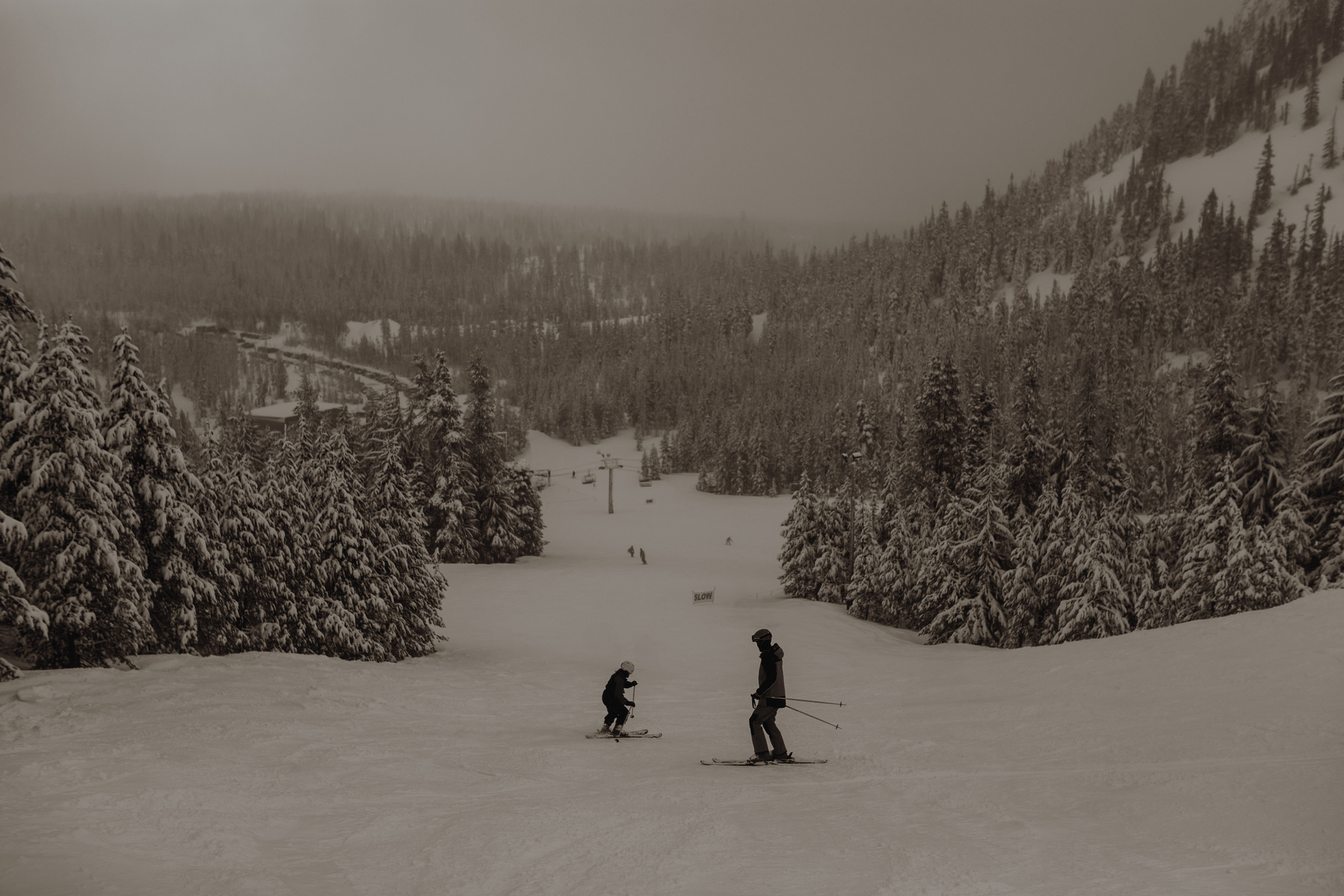 Photo of couple skiing down run at Hoodoo Ski Resort in Oregon.