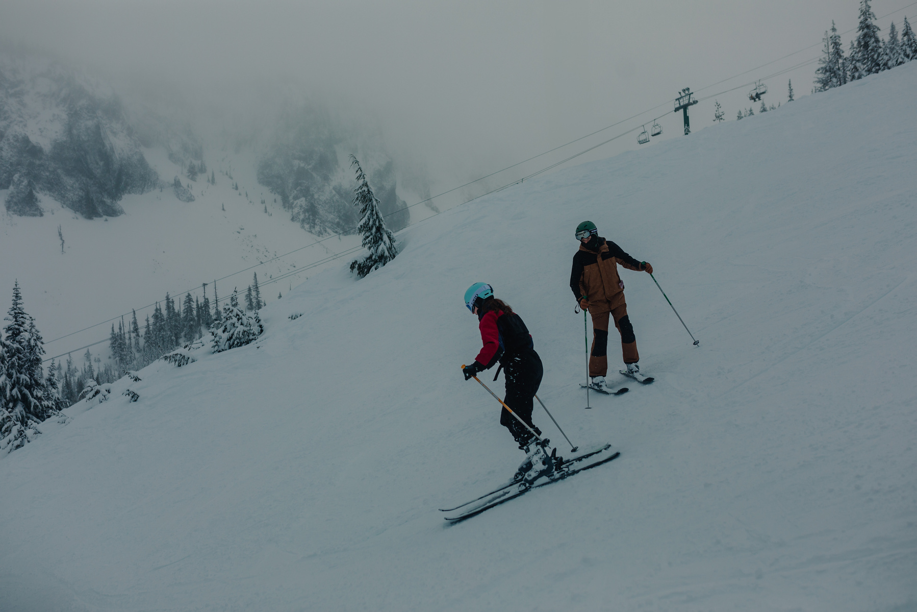 Couple skiing down the mountain at Hoodoo Ski Resort