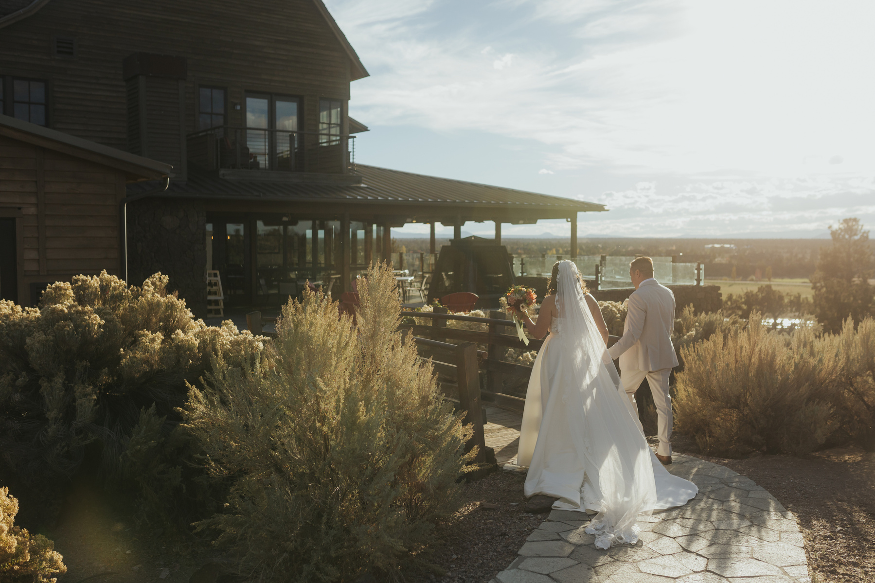 photo of bride and groom walking into Brasada Ranch after their ceremony at their wedding 