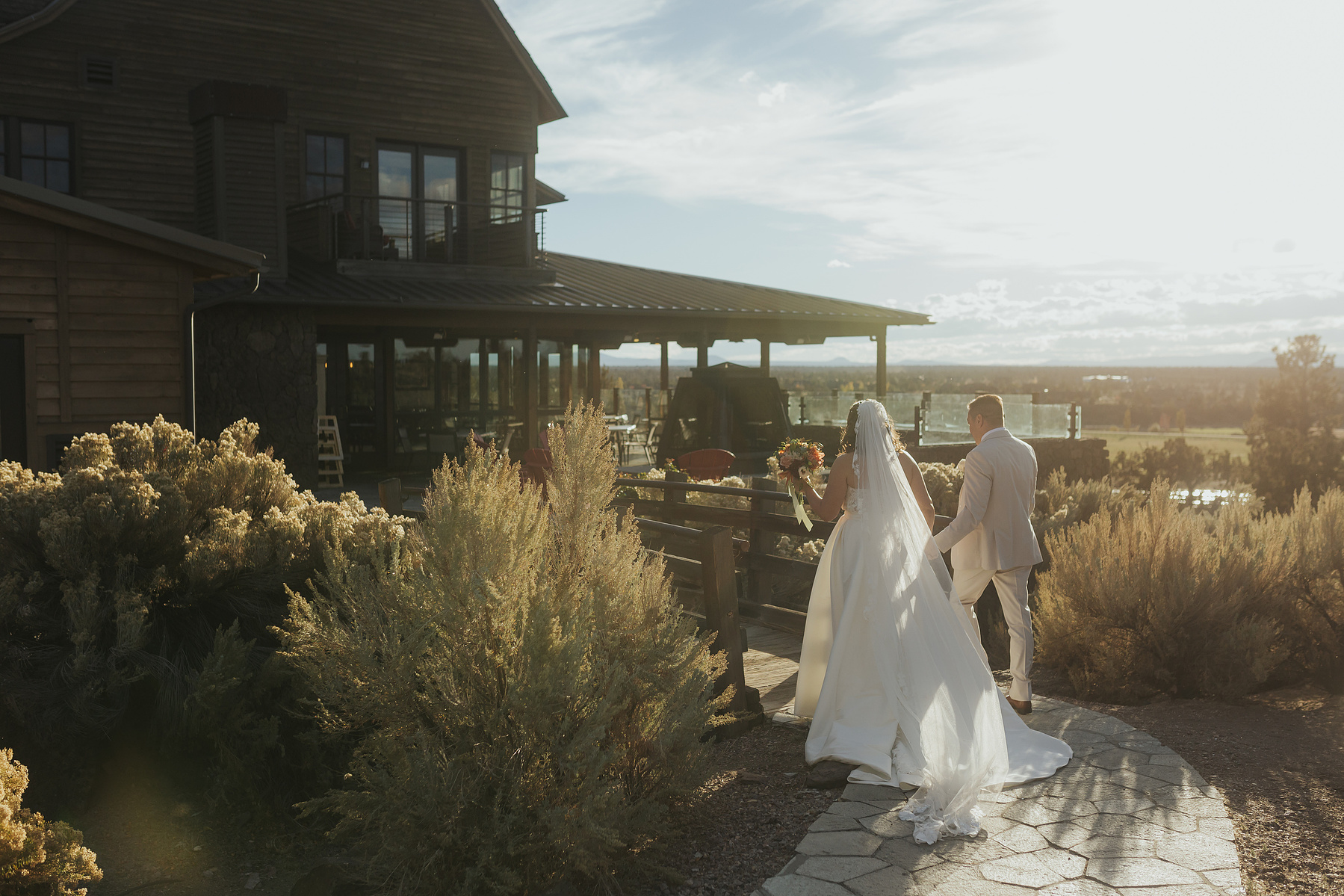 photo of bride and groom walking into Brasada Ranch after their ceremony at their wedding 
