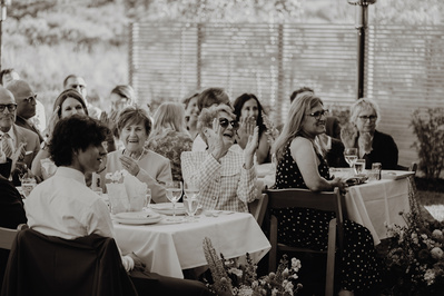 Family laughing during speeches at a wedding in Bend 