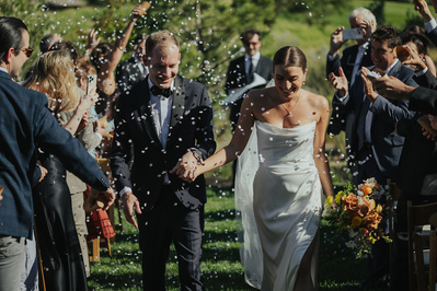 Couple exiting their wedding ceremony at Tetherow in Bend Oregon