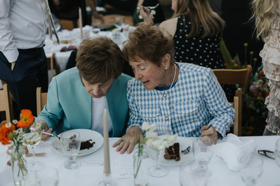 Grandmas talking to each other during wedding reception in Oregon