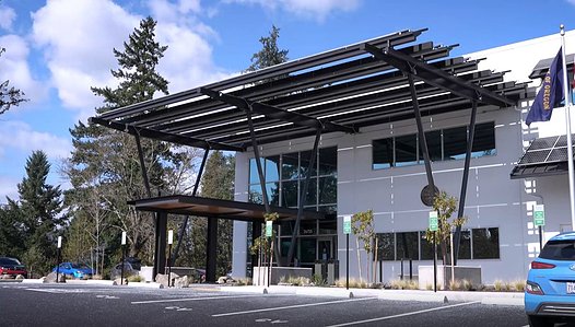Exterior shade structures consisting of solar panels incorporated into the existing tilt-up concrete building.