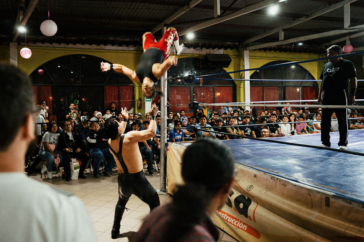 A luchador doing a back flip off the ropes of the ring in Oaxaca, Mexico.