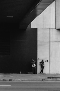 Portrait image in black and white of two skateboarders in uptown Charlotte, North Carolina taken by Matt Chandler with a Nikon DSLR camera