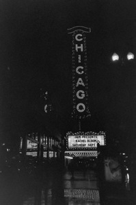 Portrait image in black and white of the Chicago theatre at night in the rain taken by Matt Chandler on a disposable film camera