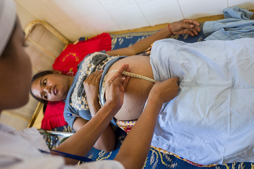 Horgn Ngi - 25 is given a pre-natal examination by Fouey Channa - Midwife at Laminh commune, Borkeo district, Ratanakiri Province Cambodia.