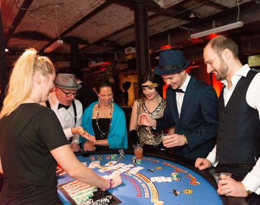 A group playing Blackjack at a casino themed party