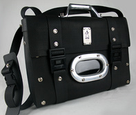 Hi Tek leather briefcase with a shoulder strap. Has solid cast aluminum porthole and handle.