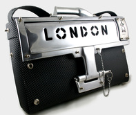 Hi Tek leather briefcase with shoulder strap. Has unusual locking device and solid cast aluminum London letterbox front face, ir=tems can be inserted in the bag without having to open the flap.Pick pockets beware! you cannot crack this one!