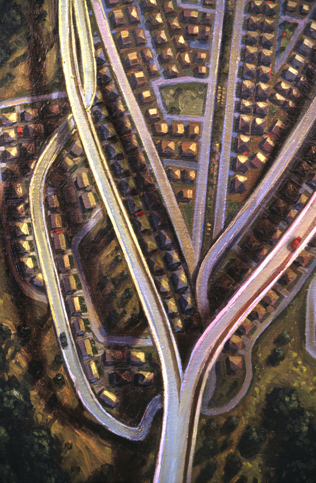 Aerial view of a tract house development, with highways and overpasses forming an insect-like outline, close-up.