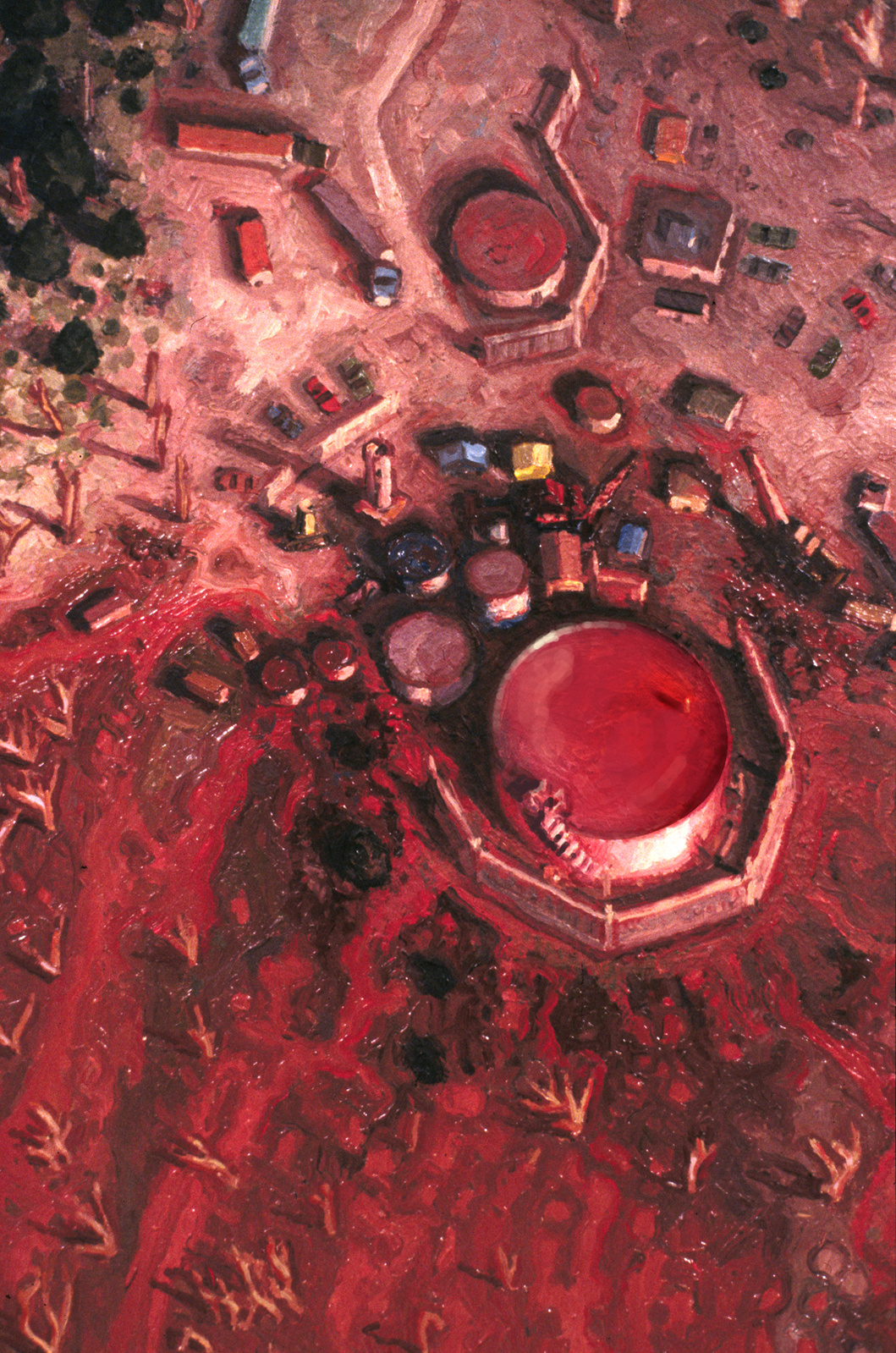 Aerial view of a bauxite mining camp and storage tank staining the landscape, close-up