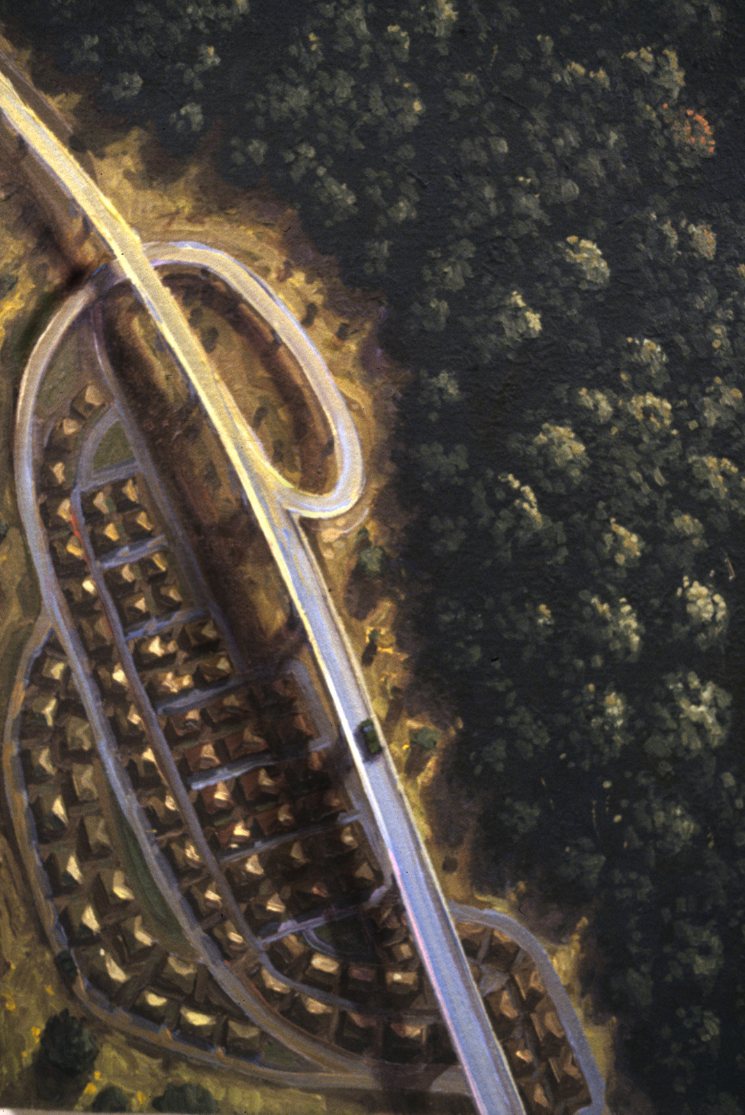Aerial view of a tract house development, with highways and overpasses forming an insect-like outline, close-up.