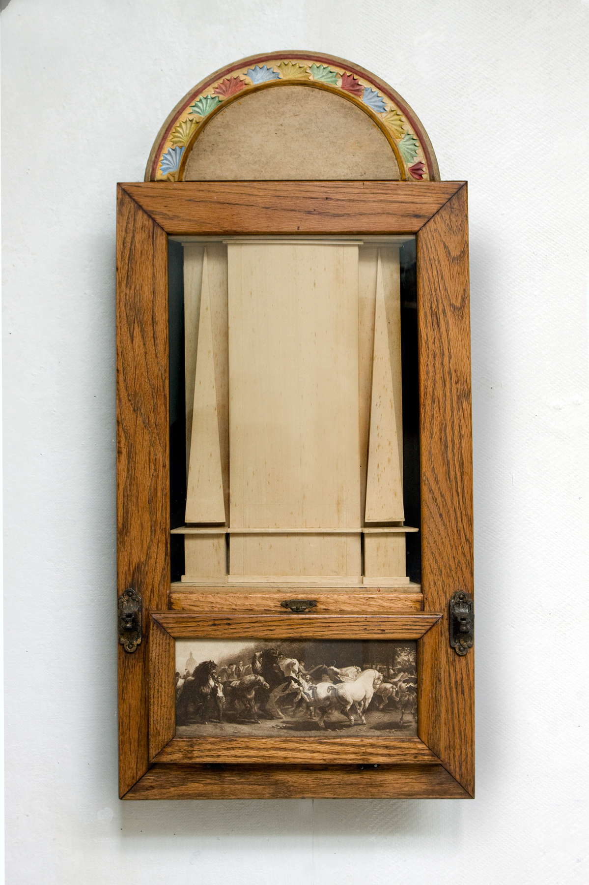 The center compartment contains a neo-classical structure. At top is a Renaissance-style lunette. The bottom panel shows a reproduction of Bonheur's "Horse Market", which opens to reveal the lower body and legs of a cadaverous horse in motion.