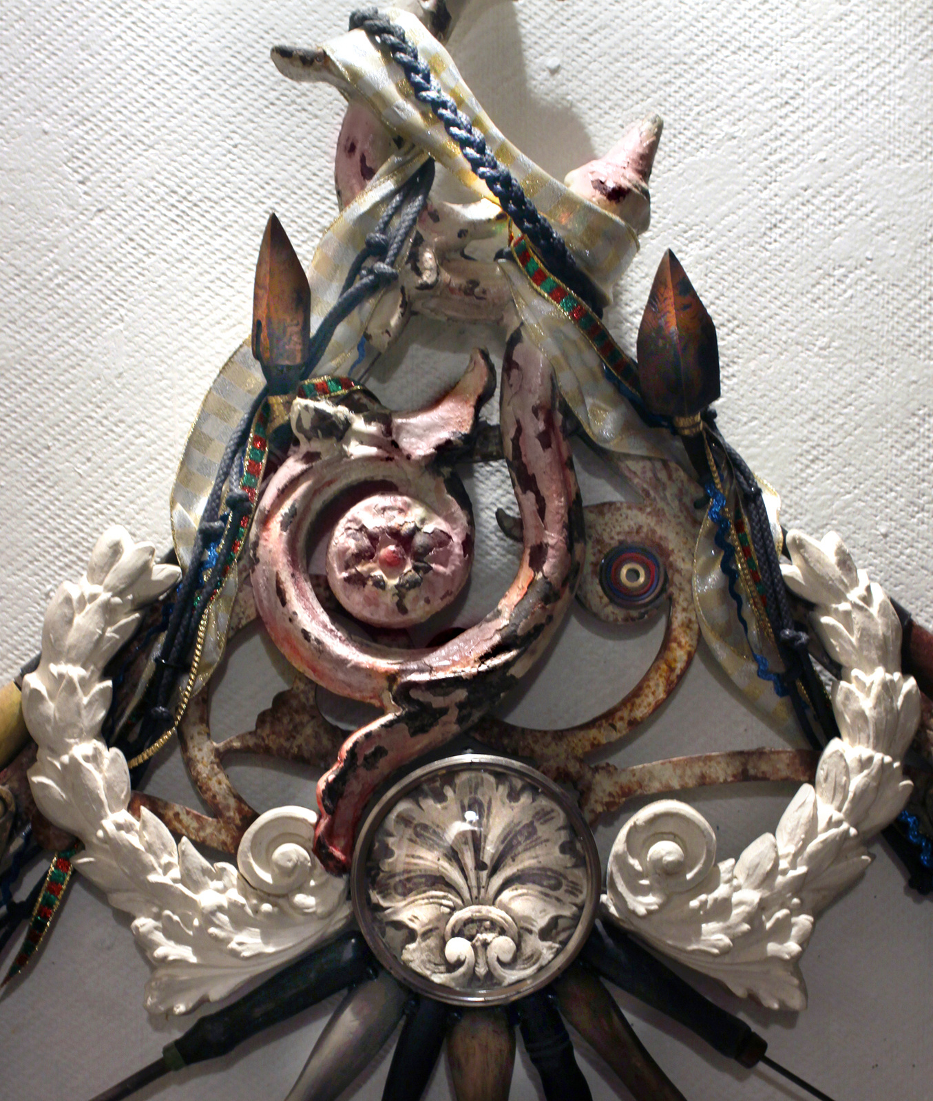 Wall assemblage referencing diverse religious iconography, devotion and penance. Detail
