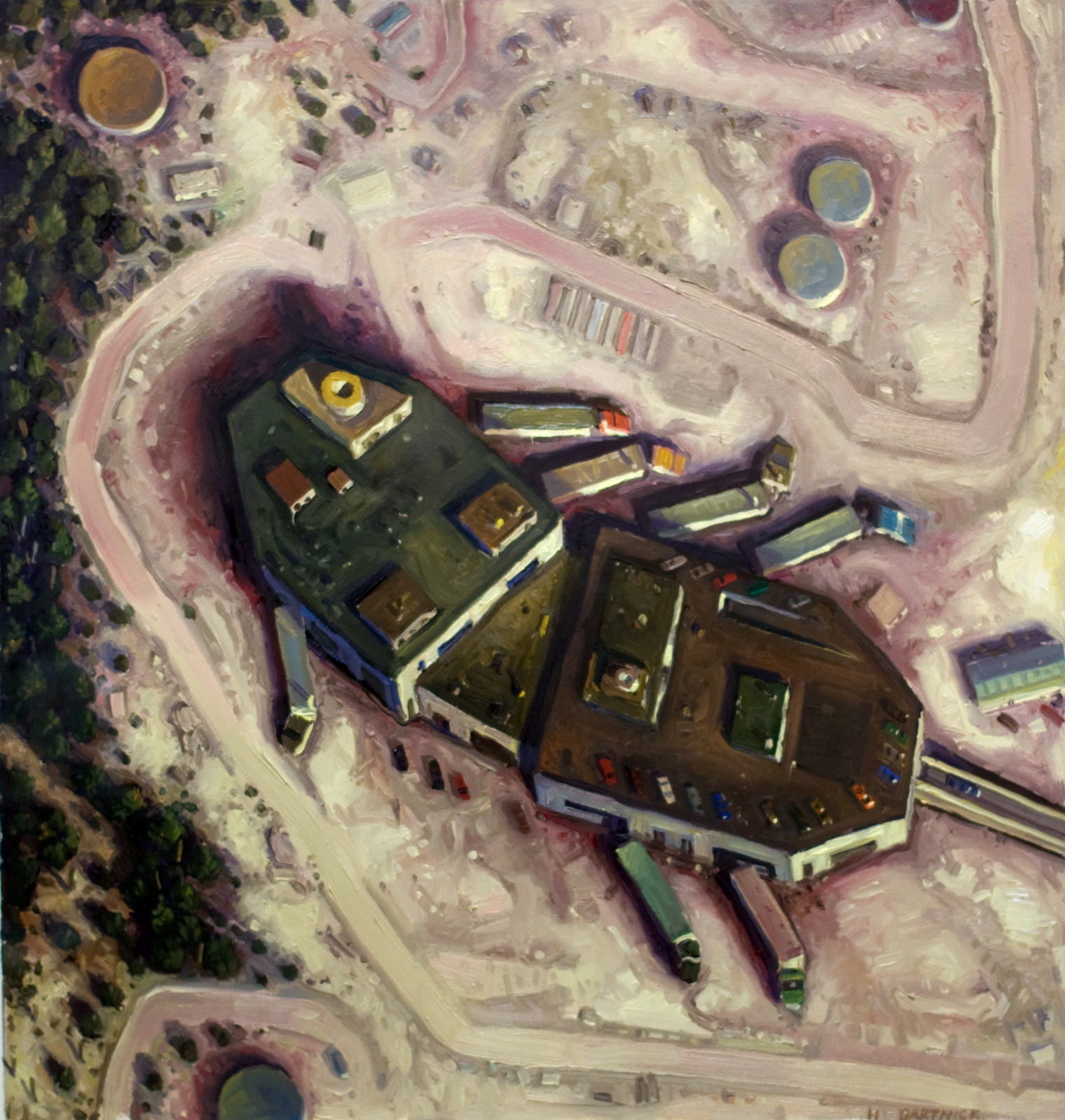 Aerial view of a factory and trucks at loading docks, forming a bacteria-like image.