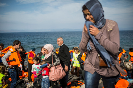 Families arriving on the island of Lesbos after crossing from Turkey on a rubber dingy.