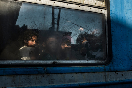 Migrants waiting for a train in Gevgelija, Macedonia  after crossing the border on foot from Greece. 