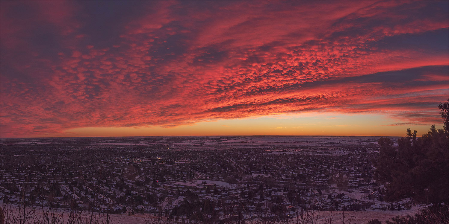 blanket of colorful clouds over Boulder, colorado on a snowy morning