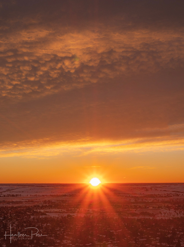sunrise photography as the sun just comes over the horizon creating a sun star, boulder, colorado