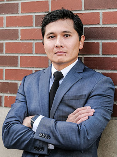 On-location portrait of a man in blue/grey suit in an urban location. These kinds of portraits, or. headshots, clearly portray individuality, professionalism, and personality.