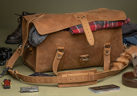 Leather bag shot in studio, and styled with props showing intended use. This is an excellent way to display products, and takes professional execution.