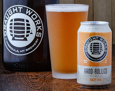 Still life image with beer growler, a full, frosty pint of beer, and a can of the same brand. Products are high lighted, and glow in professional studio lighting. 