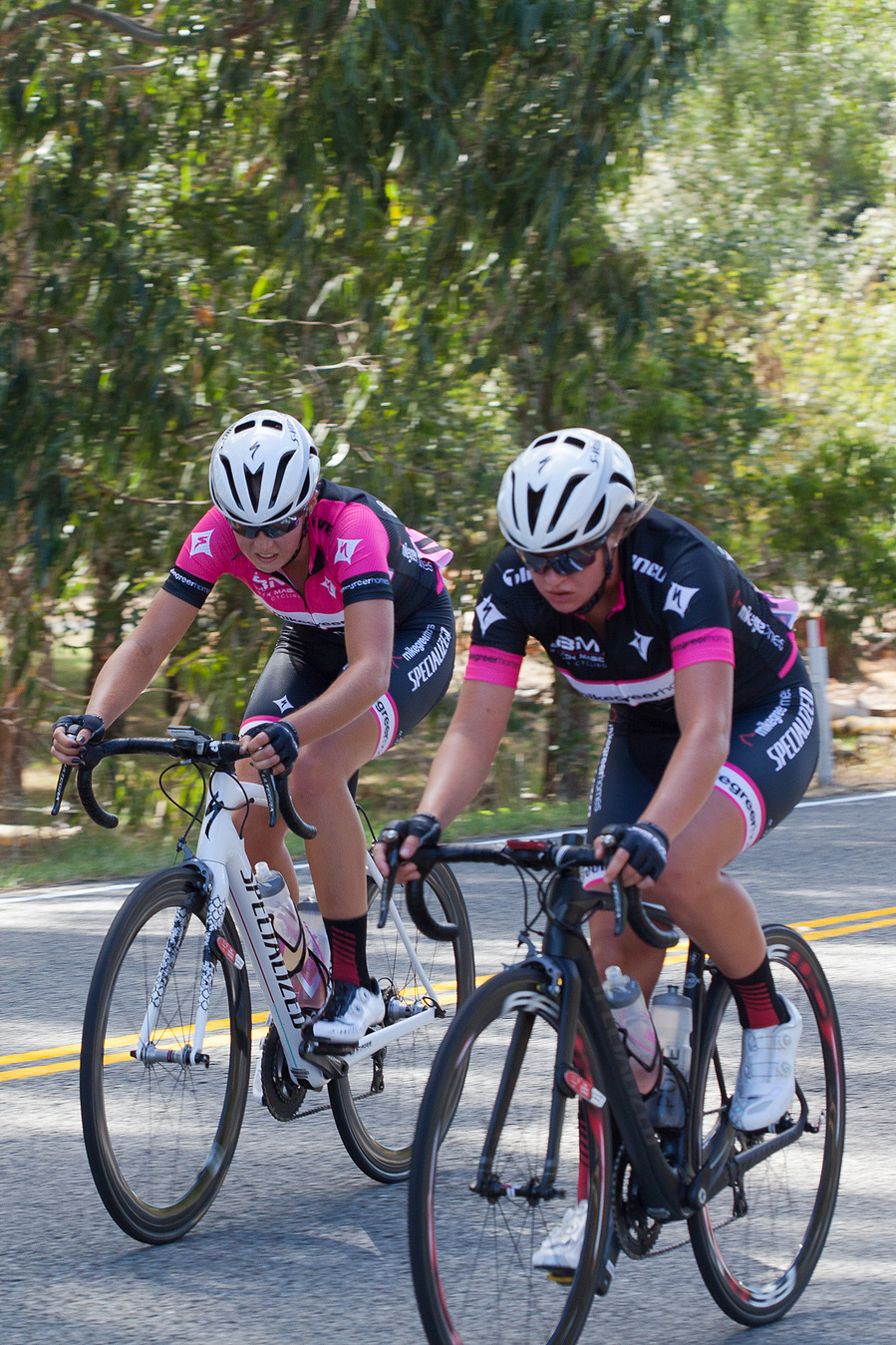 Two cyclists side-by-side approaching the finish link.