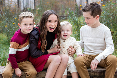 Family in front of greenery getting photographed by Atlanta Photographers David and Jess.