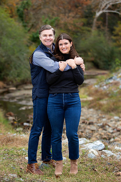 Couple in front of greenery, getting photographed by Atlanta Engagement Photographers David and Jess.