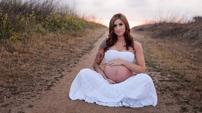 Pregnant lady getting her pictures taken by a Maternity photographer in Atlanta.