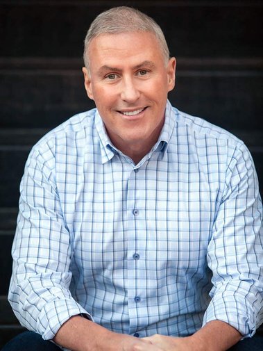 Man sitting on stairs, posing for his Atlanta dating photographer.