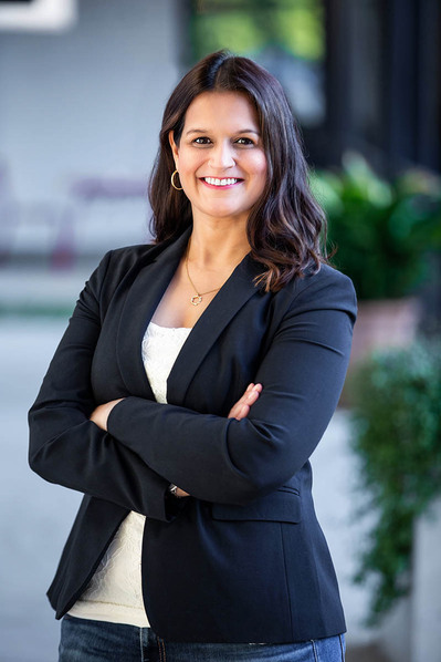 Lady in suit getting pictures taken by a Linkedin Headshot photographer in Atlanta.