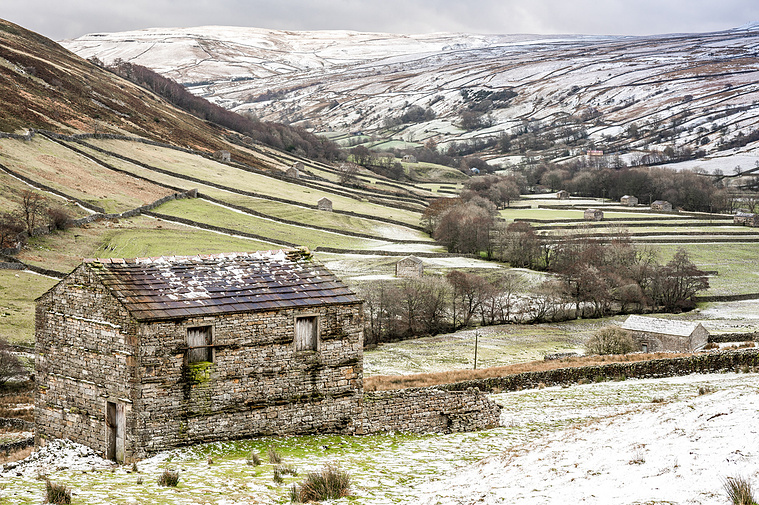 Photograph of Swaledale in winter with a field barn and Thwaite meadows
