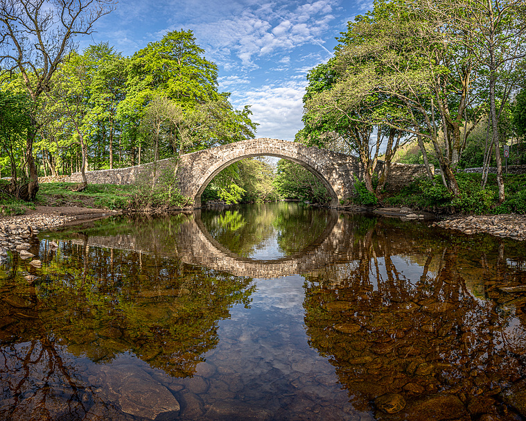 Photograph of a large pack horse bridge over the river Swale taken in early summer