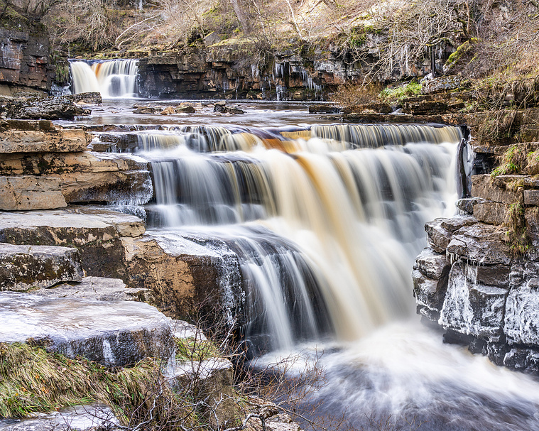 Photograph of a double drop waterfall in Kisdon Gorge during winter, close to the village of Keld
