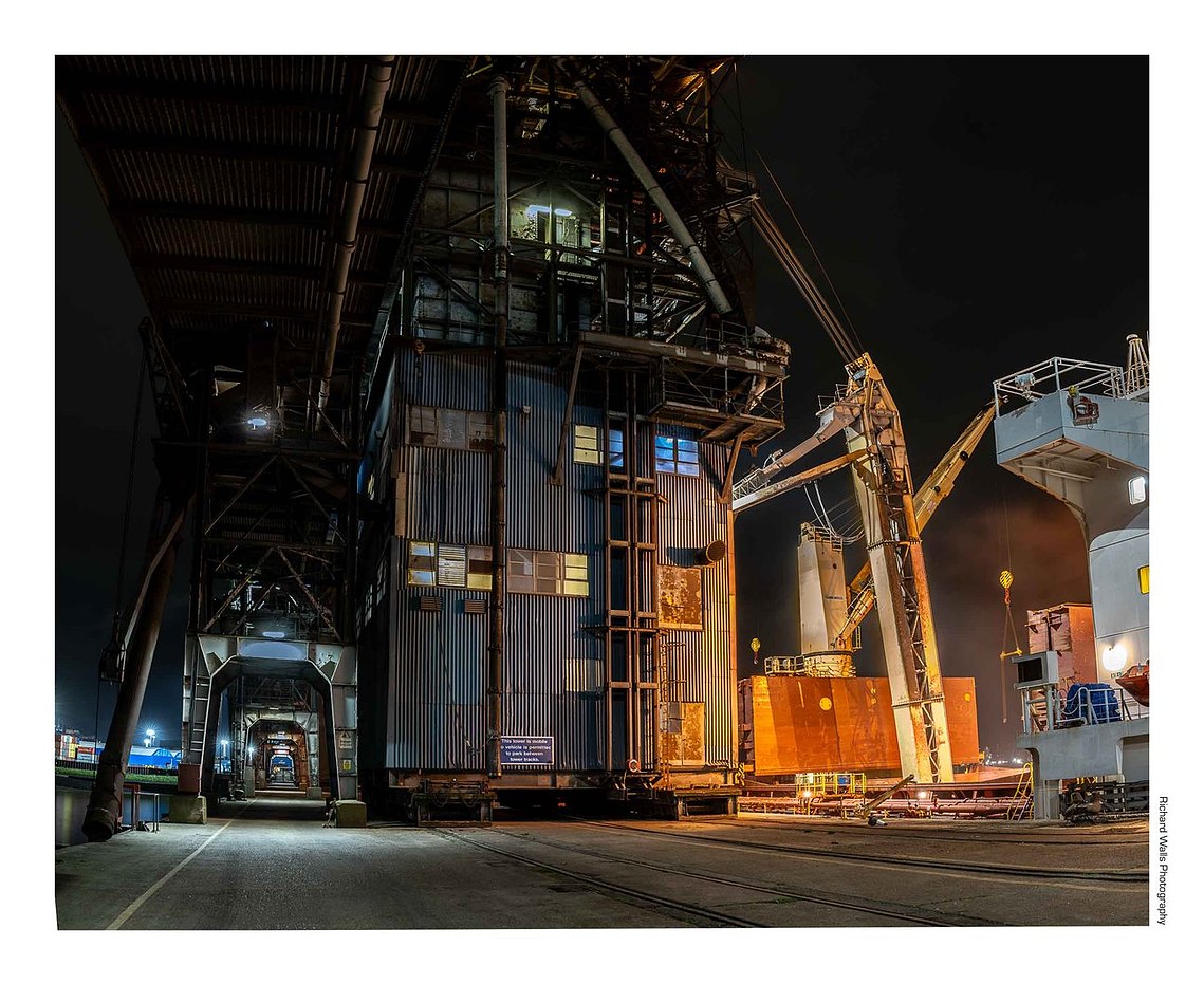 Grain being unloaded from a ship at Tilbury Grain Terminal after dark 