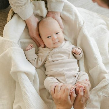 Newborn baby looking and smiling at the camera