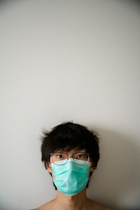 I wear a surgical mask included in the quarantine kit Sunday, Nov. 15, 2020. I must mask up whenever I leave my quarantine space, even to go to the bathroom directly adjacent to my room. My mother must also mask up in her own apartment due to my quarantin