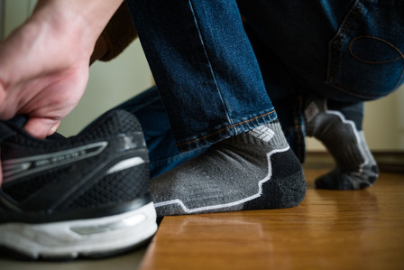 I reach for my shoe after getting dressed Friday, Nov. 27, 2020.