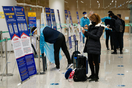 A traveler arriving at the Incheon International Airport installs a mandatory quarantine and contact tracing app Friday, Nov. 13, 2020. Incoming international travelers must self-report symptoms using the app during a mandatory 14-day quarantine, either a